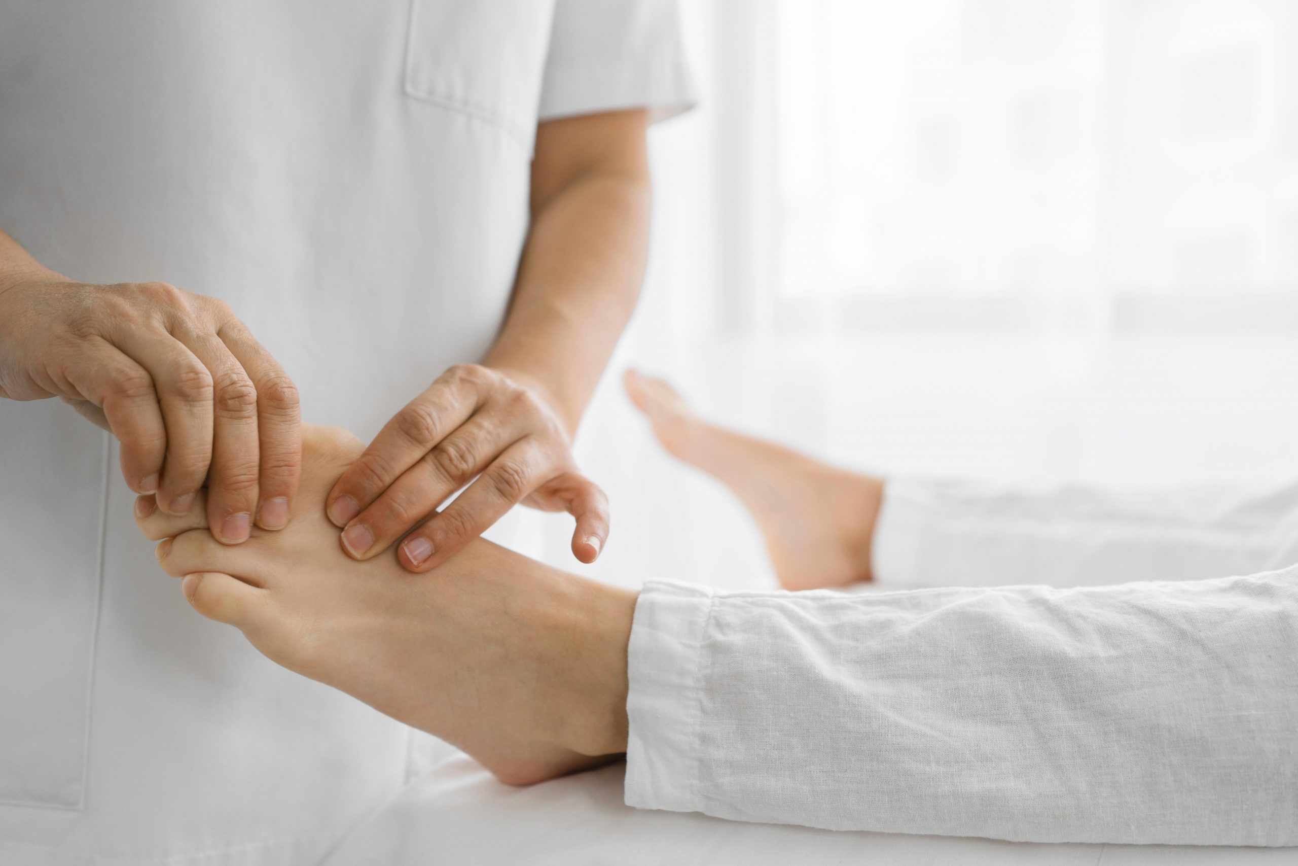 osteopathist-treating-patient-his-feet